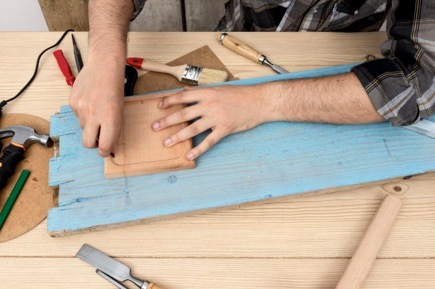 Craftsman shaping a wooden frame